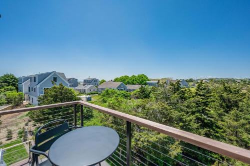 a table and chairs on the balcony of a house at 37 Clam Shell Drive Chatham - Slow M'Ocean in Chatham