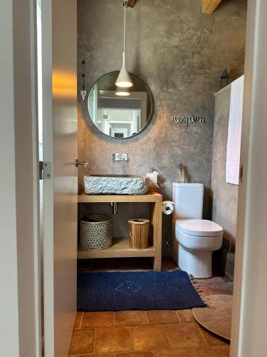 a bathroom with a sink and a mirror at Amélia's House (Casa das Amélias) in Grândola