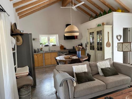 a living room with a couch and a table at Amélia's House (Casa das Amélias) in Grândola