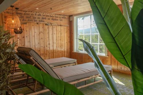 a room with a chair and a window at Pollfoss Boutique Hotel & Spa in Skjåk