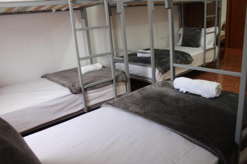 a room with three bunk beds in a room at Crew Hostel Tirana in Tirana