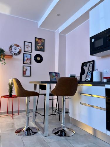 a room with a table and chairs and a counter at Suite Bohémien Chic - A 5 Fermate dal Duomo in Milan