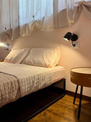 a bedroom with a bed with a lamp and a table at Suite Bohémien Chic - A 5 Fermate dal Duomo in Milan