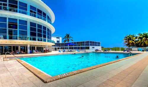 a large swimming pool in front of a building at Castle B6 in Miami Beach