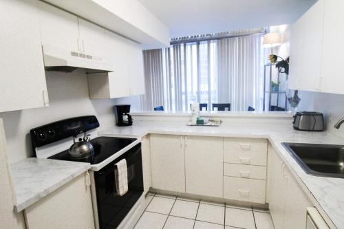 a white kitchen with a sink and a stove at Castle B6 in Miami Beach