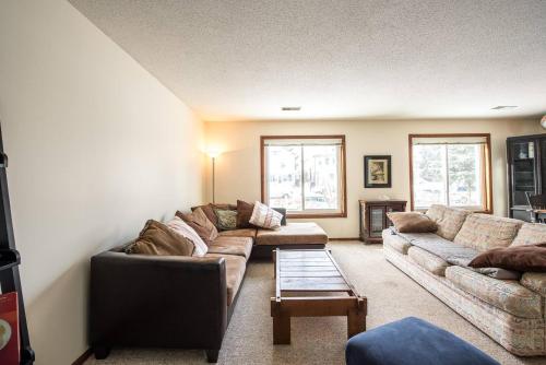 a living room with two couches and a coffee table at Dream House, a Creative Escape in the Heart of Powderhorn in Minneapolis