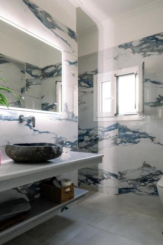 a bathroom with a sink and a mirror at Villa Hermes in Potamós