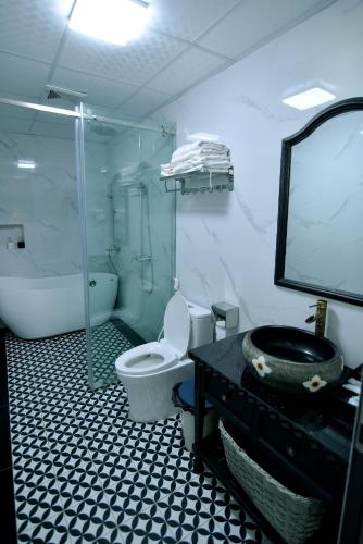 a bathroom with a toilet and a sink and a shower at Lotus Hotel Ninh Bình in Ninh Binh