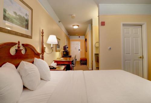 a bedroom with a bed with white pillows at Senator Inn & Spa in Augusta