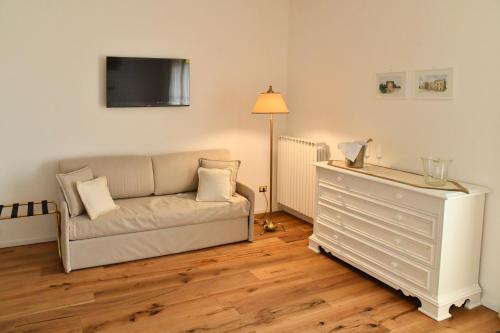 a living room with a couch and a dresser at Casa FEREMI in Cavallino di Lecce
