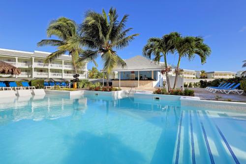 a large swimming pool in front of a resort at The Signature Level at Grand Palladium Lady Hamilton Resort & Spa- All Inclusive in Lucea