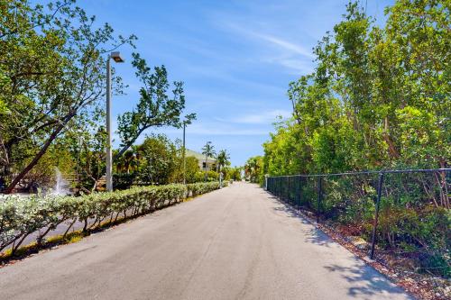 a dirt road next to a fence and trees at Sunrise Suites - Saint Kitts 412 in Key West