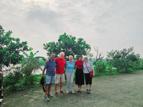 a group of people posing for a picture on a road at Lotus Hotel Ninh Bình in Ninh Binh
