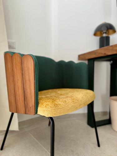 a wooden chair sitting in front of a desk at Anno13Suites in Naples