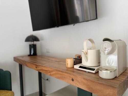 a wooden table with a sink and a toaster on it at Anno13Suites in Naples