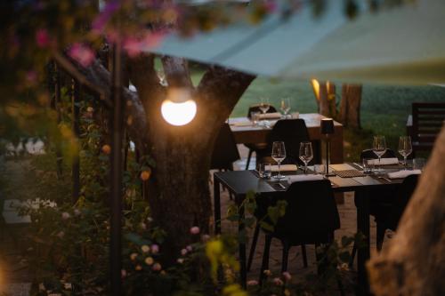 a restaurant with tables and chairs and a tree at Mami Sabaudia Hotel in Sabaudia