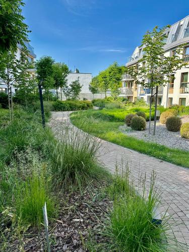 a path through a park with buildings and grass at Nice Sopot in Sopot