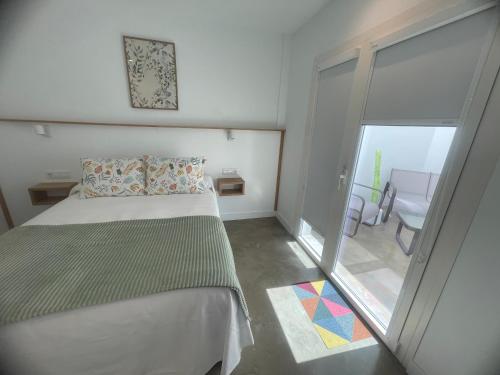 a bedroom with a bed and a large window at Ventana del Nublo 1D in Tejeda