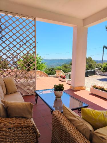 a living room with a glass table and chairs at Domus Valentina in Selva di Fasano