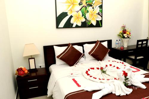 a bedroom with a large bed with white towels on it at Kubu Garden Suites & Villas Nusa Dua in Nusa Dua