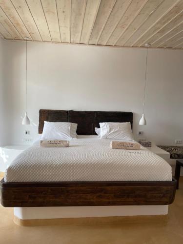 a bedroom with a large bed with two pillows at KLIDON Dreamy Living Suites in Mikonos