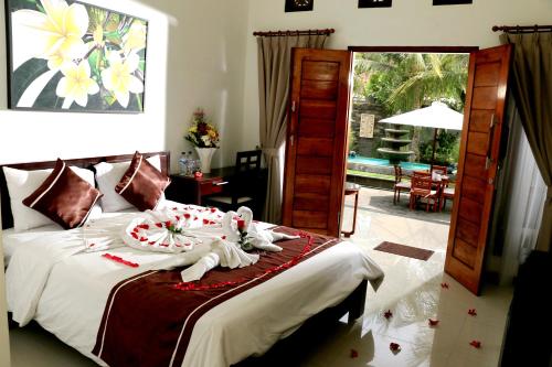 a bedroom with a bed with towels on it at Kubu Garden Suites & Villas Nusa Dua in Nusa Dua