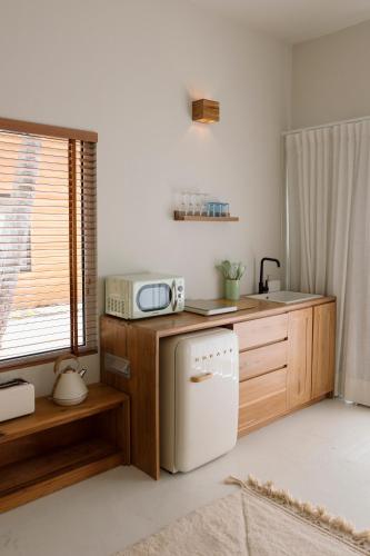 a kitchen with a sink and a microwave at Sentidos Beach Retreat in Miramar