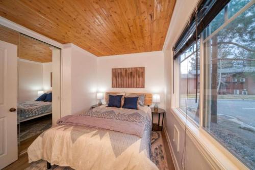a bedroom with a bed and a large window at Moose and Maple Lodge in South Lake Tahoe