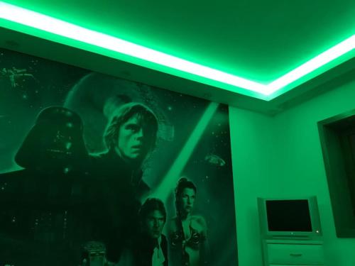 a green light on a movie poster in a room at Hollywood Apartment in Bragança