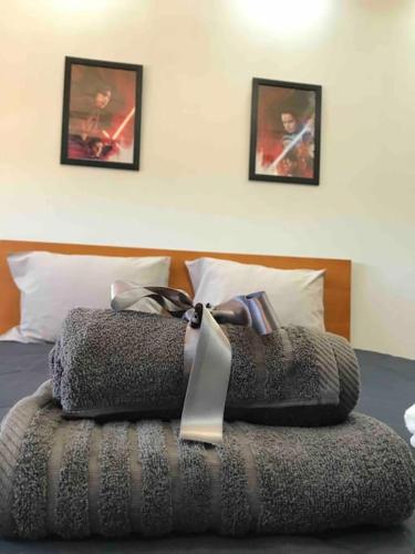a bed with a ribbon on top of it at Hollywood Apartment in Bragança