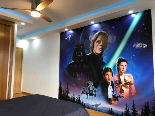 a large poster of a star wars movie on a wall at Hollywood Apartment in Bragança