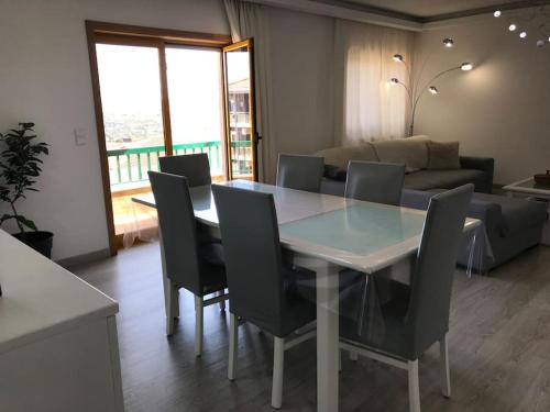 a dining room with a table and chairs and a couch at Hollywood Apartment in Bragança