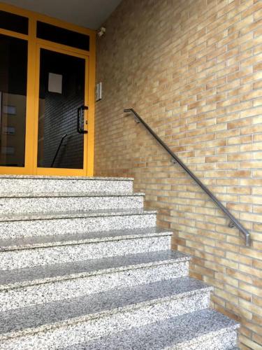 a set of stairs in front of a brick building at Hollywood Apartment in Bragança