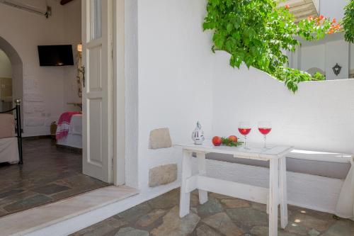 a table with two glasses of red wine on it at Anastasia's Triovasalos in Triovasálos