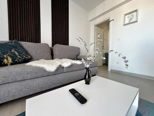 a living room with a couch and a table at Apartman Sjever in Makarska