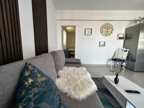 a living room with a couch and a table at Apartman Sjever in Makarska