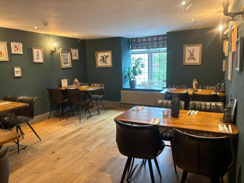 a dining room with tables and chairs in a restaurant at Aleppo Merchant Inn in Carno