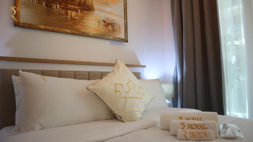a white bed with two pillows on top of it at Dainty 1BR Apartment in Masdar - Cozy Stay Near Masdar Park & City Centre in Abu Dhabi