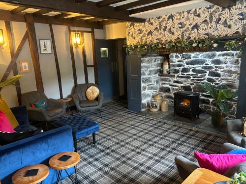 a living room with a couch and a fireplace at Aleppo Merchant Inn in Carno