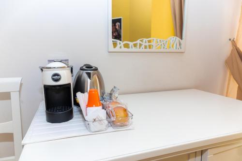 a coffee maker sitting on a white counter top at Santa Sofia Affittacamere in Gravina in Puglia