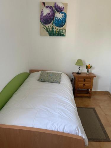 a bedroom with a bed and a table with a picture on the wall at Casa Don Daniel in Arona