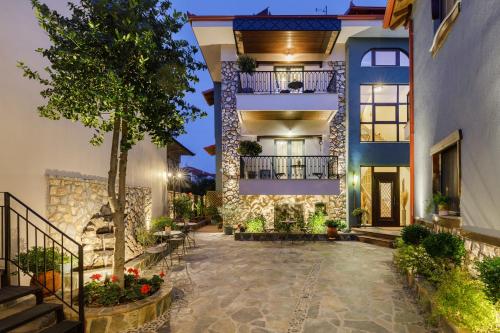 an exterior view of a house with a courtyard at Meydani Suites in Litochoro