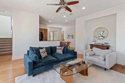a living room with a blue couch and a table at Bright Home in East ATX - 3BR - Cowboy Pool in Austin