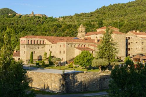 an old building with a mountain in the background at Hotel & Spa Monasterio de Boltaña in Boltaña