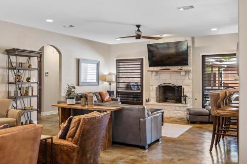 a living room with a television and a fireplace at 4 Bedroom Close to Downtown Hot Tub-Pool in Fredericksburg