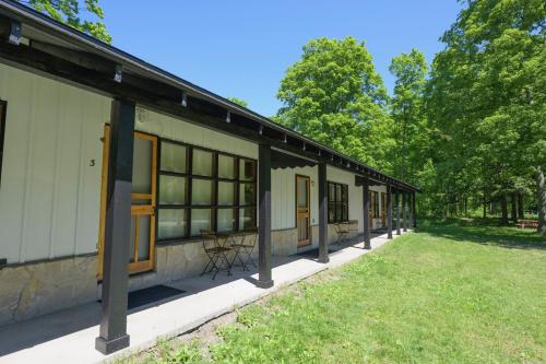 a row of windows on a building with a yard at Dune Climb Inn in Empire
