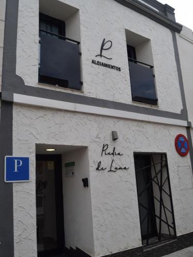 a white building with graffiti on the side of it at PIEDRA DE LUNA in Merida