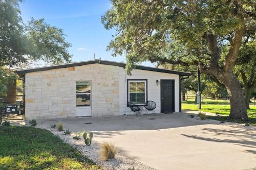 a small brick building with a bench in front of it at Leisure Escape - TX Hill Country in Dripping Springs