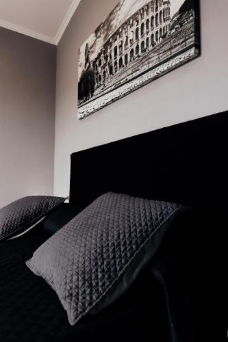 a bedroom with a bed and a picture on the wall at Villa Erasi in Fiumicino