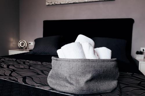 a basket of towels sitting on top of a bed at Villa Erasi in Fiumicino